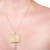 Celtic knot necklace made in yellow gold plated brass. Square shaped. On gold chain.